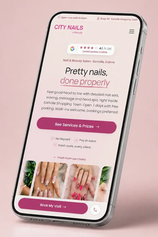 City Nails & Beauty mobile website displayed on an angled silver phone in a blush-pink studio